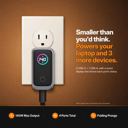 ReelCharge 140W 4-in-1 Laptop Charger plugged into wall outlet — smaller than you'd think, powers your laptop and 3 more devices